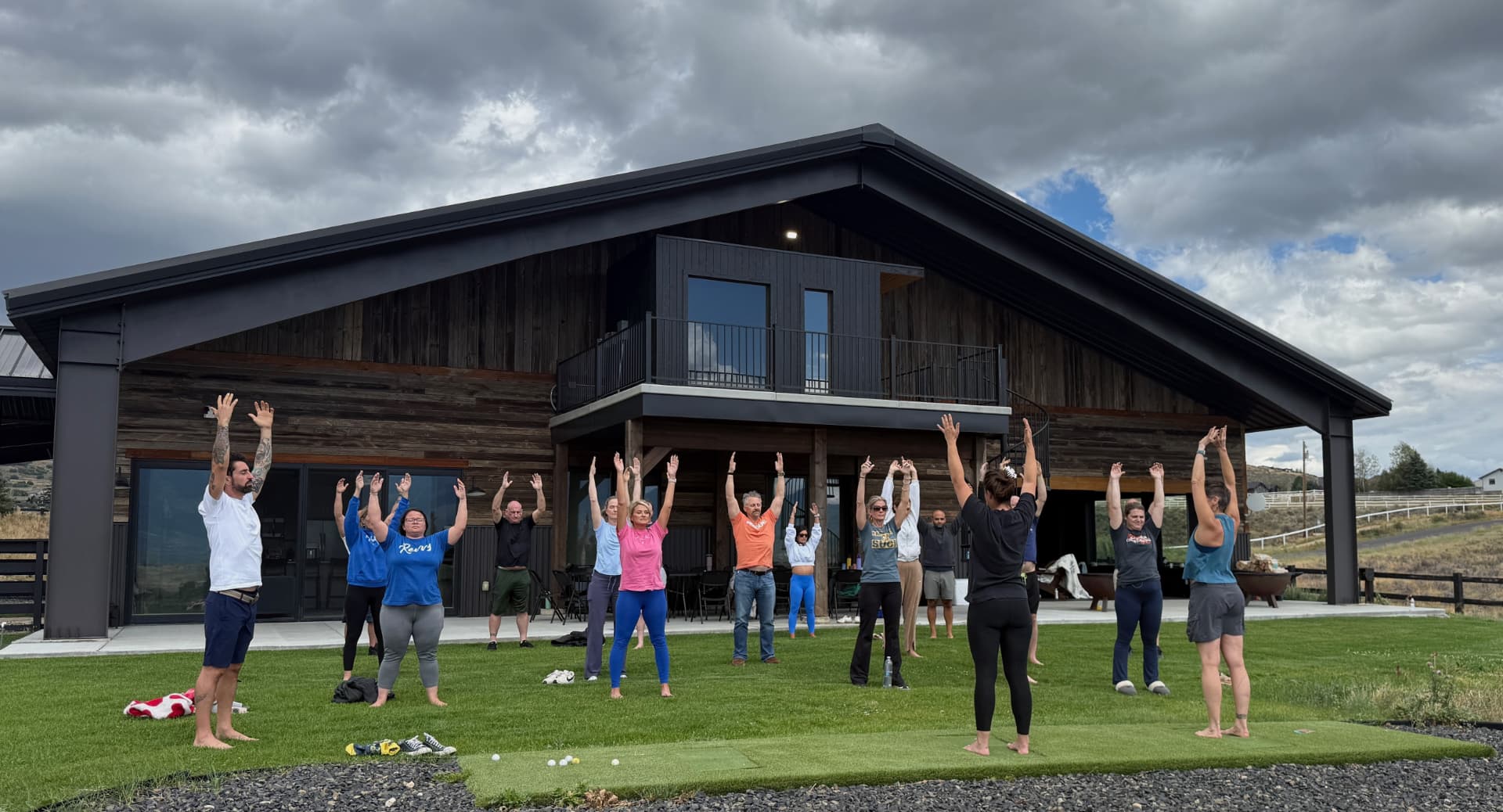 Morning movement and stretching on the lawn in front of the barn