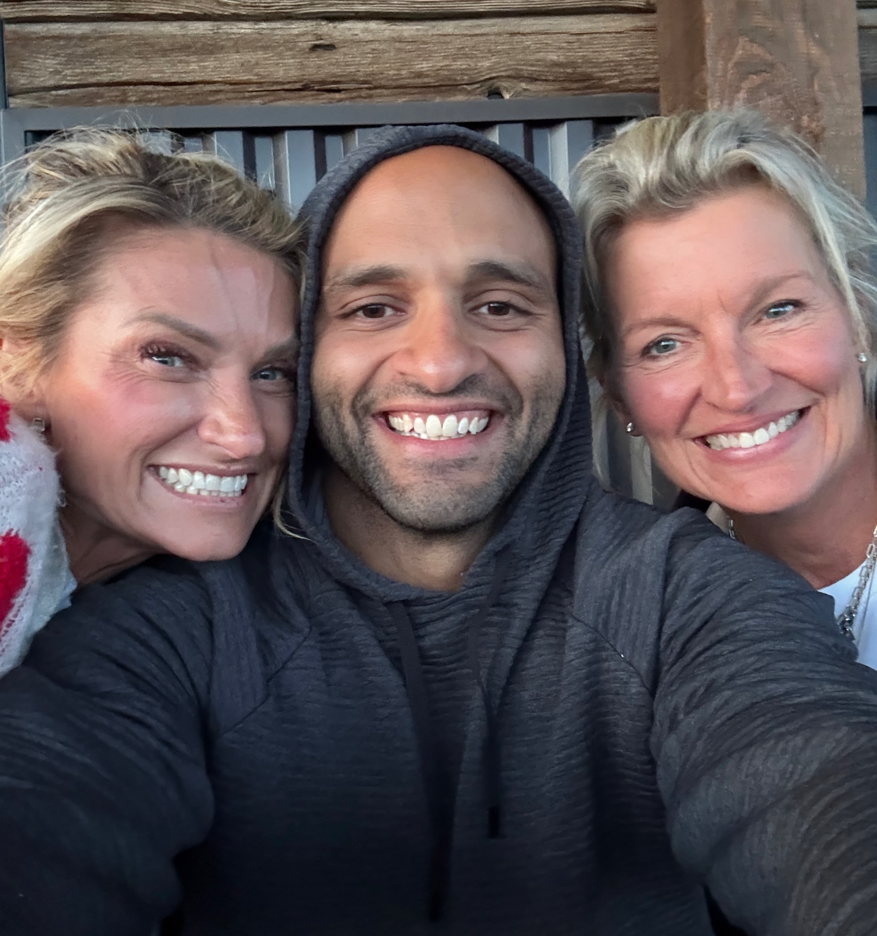 Three participants sharing a smile on the estate porch